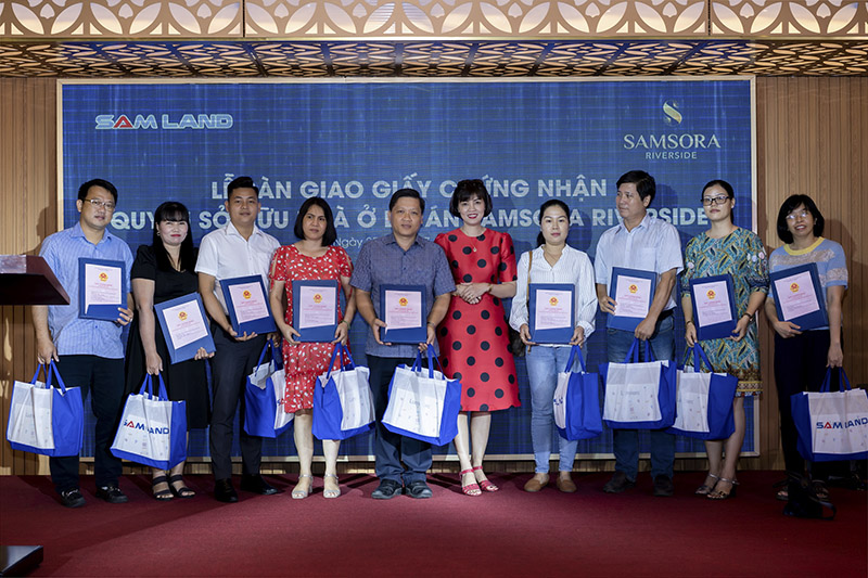 Residents of Samsora Riverside receive their pink books (land use rights certificates) from the developer, Samland